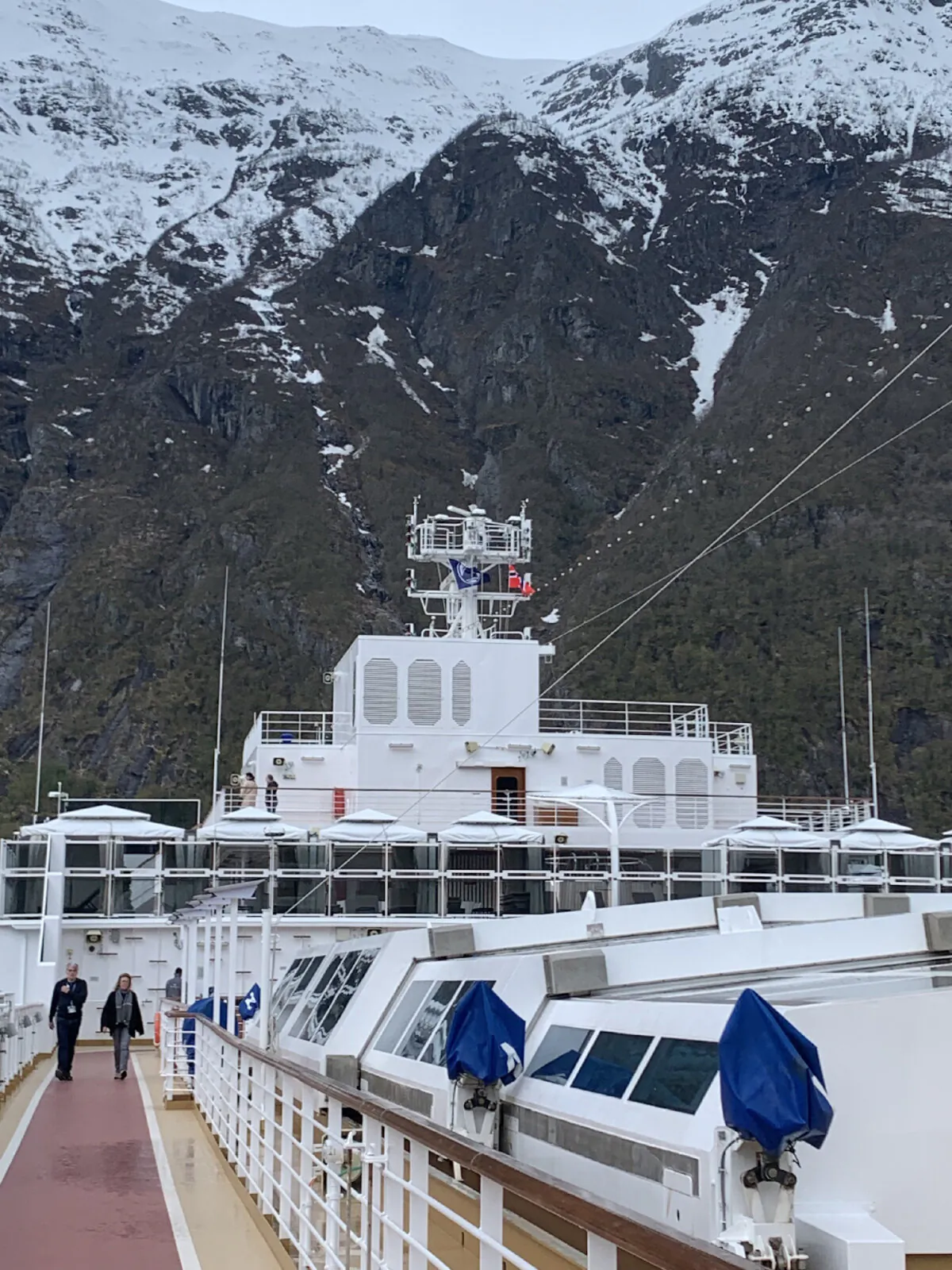 Passengers stroll on the top deck of the Holland America Rotterdam, docked outside charming Eidfjord, Norway, population around 1,000. (Photo courtesy of Sharon Whitley Larsen)