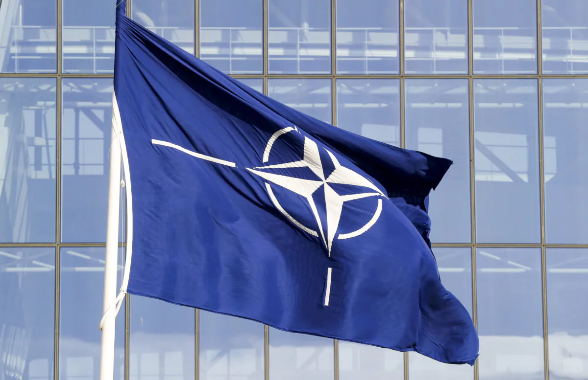A NATO flag is displayed at the Alliance headquarters ahead of a NATO Defense Ministers meeting, in Brussels, on Oct. 21, 2021. (Pascal Rossignol/Reuters)