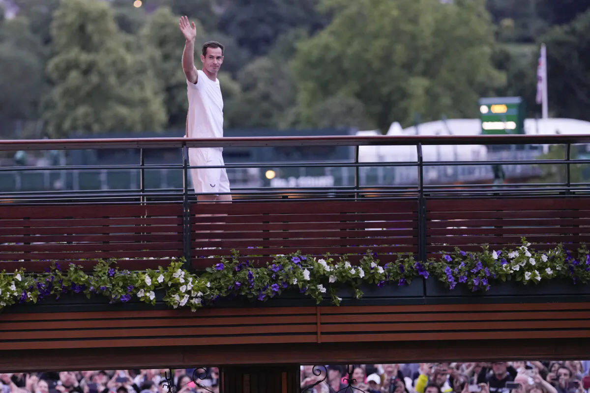 Britain's Andy Murray waves as he leaves Center Court following his first round doubles loss at the Wimbledon tennis championships in London on July 4, 2024. (Alberto Pezzali/AP Photo)