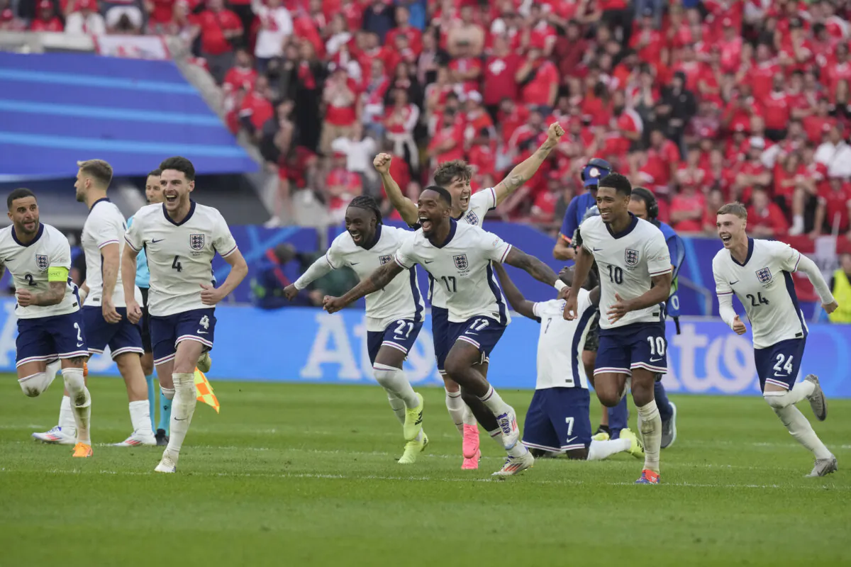 England players celebrate after Trent Alexander-Arnold scored the winning goal during the penalty shootout of a quarterfinal match between England and Switzerland at the Euro 2024 soccer tournament in Duesseldorf, Germany, on July 6, 2024. (Martin Meissner/AP Photo)