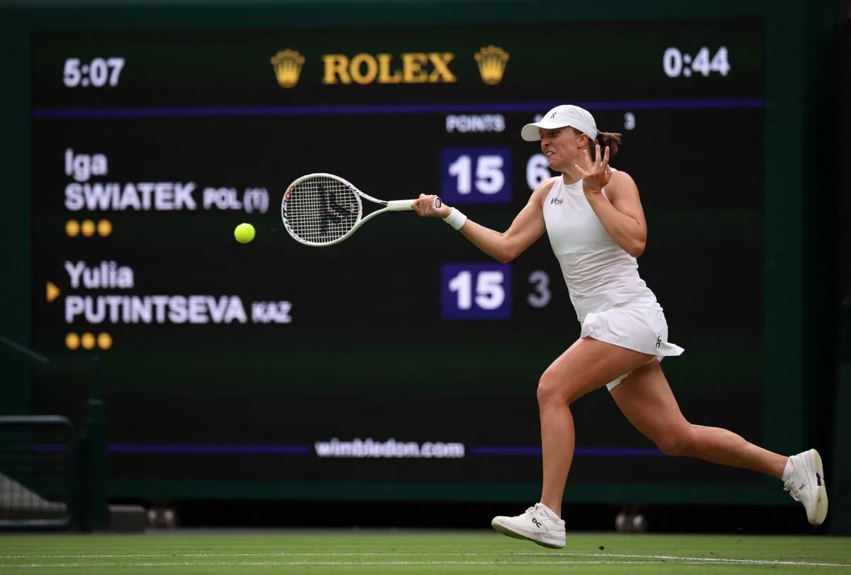 Poland's Iga Swiatek returns against Kazakhstan's Yulia Putintseva during their women's singles tennis match on the sixth day of the 2024 Wimbledon Championships at The All England Lawn Tennis and Croquet Club in Wimbledon, London, on July 6, 2024. (Henry Nicholls/AFP)