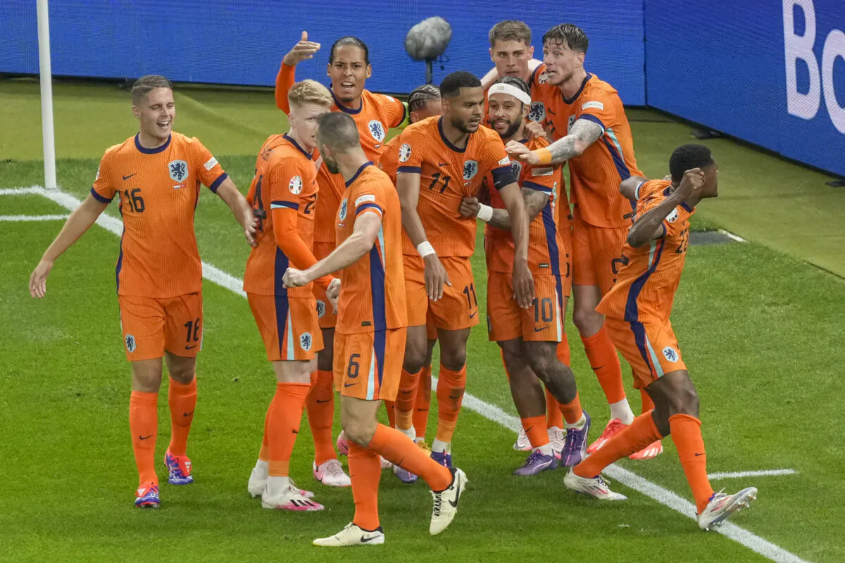 Cody Gakpo of the Netherlands (C) celebrates with his teammates after scoring a goal, that was later considered as an own goal by Turkey's Mert Muldur, during a quarterfinal match between the Netherlands and Turkey at the Euro 2024 soccer tournament in Berlin, Germany, on July 6, 2024. (Markus Schreiber/AP Photo)
