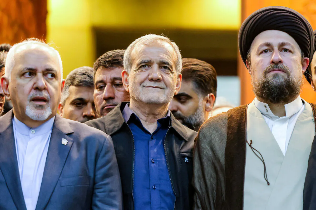 Iran's newly-elected President Masoud Pezeshkian (C), former foreign minister Mohammad Javad Zarif (L), and Hassan Khomeini (R), grandson of the Islamic Republic's founder Ayatollah Ruhollah Khomeini, visit Khomeini's shrine in the south of Tehran, Iran, on July 6, 2024. (Atta Kenare/AFP via Getty Images)