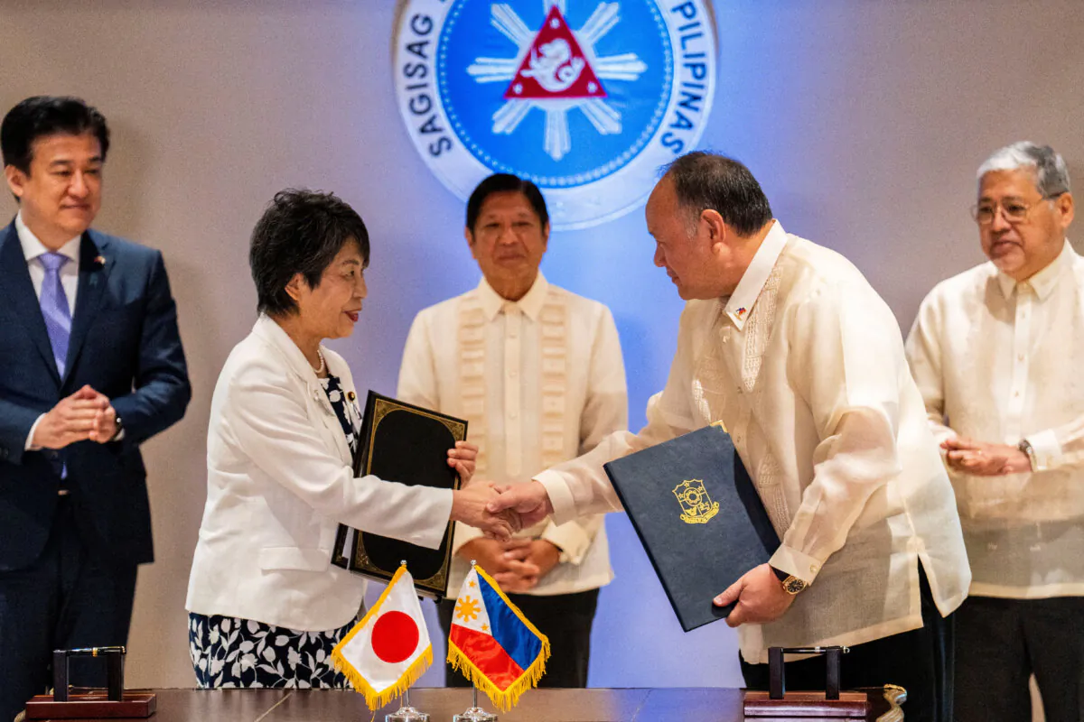 Japan's Foreign Minister Yoko Kamikawa and Philippines Defense Minister Gilberto Teodoro after signing the reciprocal access agreement at the Malacanang Palace in Manila, Philippines, on July 8, 2024. (Lisa Marie David/Reuters)