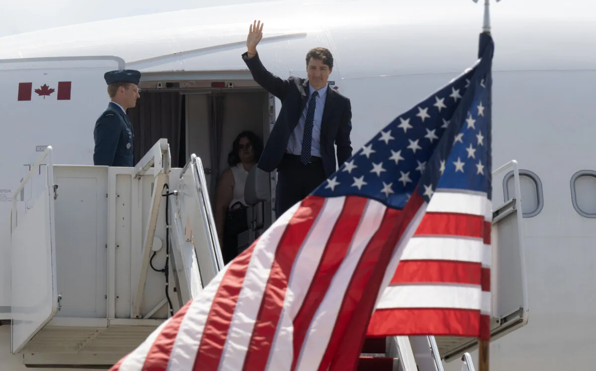 Prime Minister Justin Trudeau waves as he arrives at Andrews Airforce Base ahead of the NATO Summit in Washington on July 8, 2024. (Adrian Wyld/The Canadian Press)