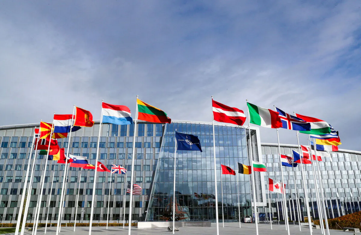 Flags wave outside NATO headquarters ahead of a meeting of the alliance's defense ministers in Brussels on Oct. 21, 2021. (Pascal Rossignol/Reuters)