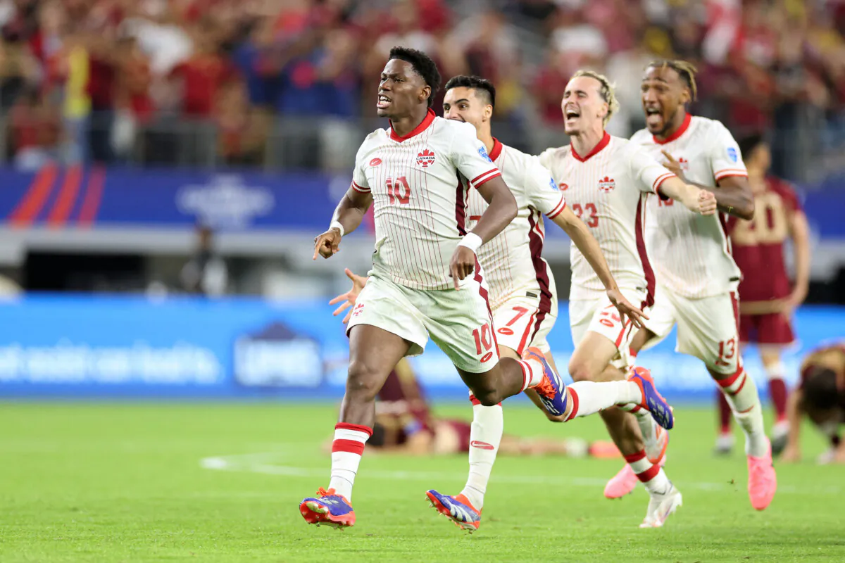 Canadian forward Jonathan David and teammates celebrate their victory after a penalty shoot-out against Venezuela during the 2024 Copa America tournament quarter-final match at AT&T Stadium in Arlington, Texas, on July 5, 2024. (Charly Triballeau/AFP via Getty Images)
