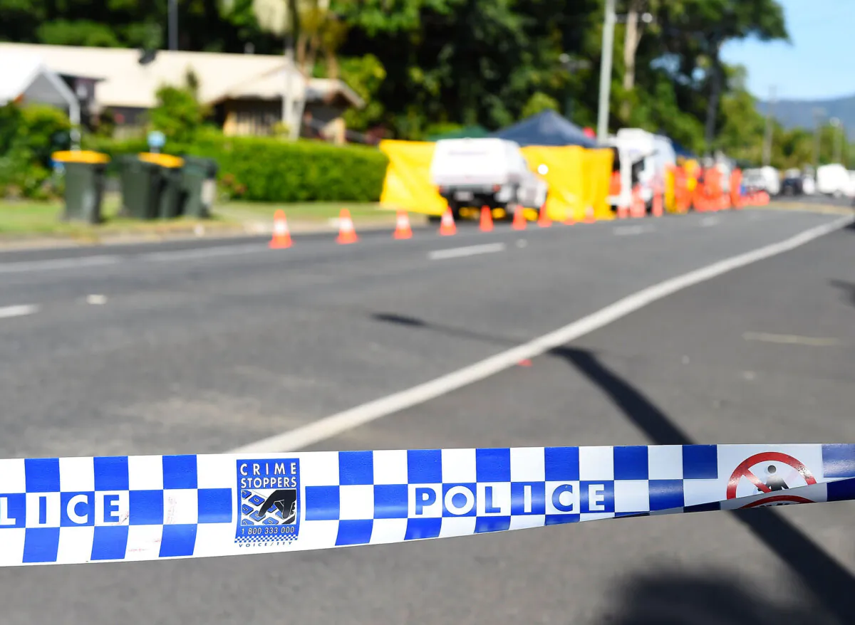 Police attend a crime scene in the suburb of Manoora in Cairns, Australia, on Dec. 19, 2014. (Ian Hitchcock/Getty Images)