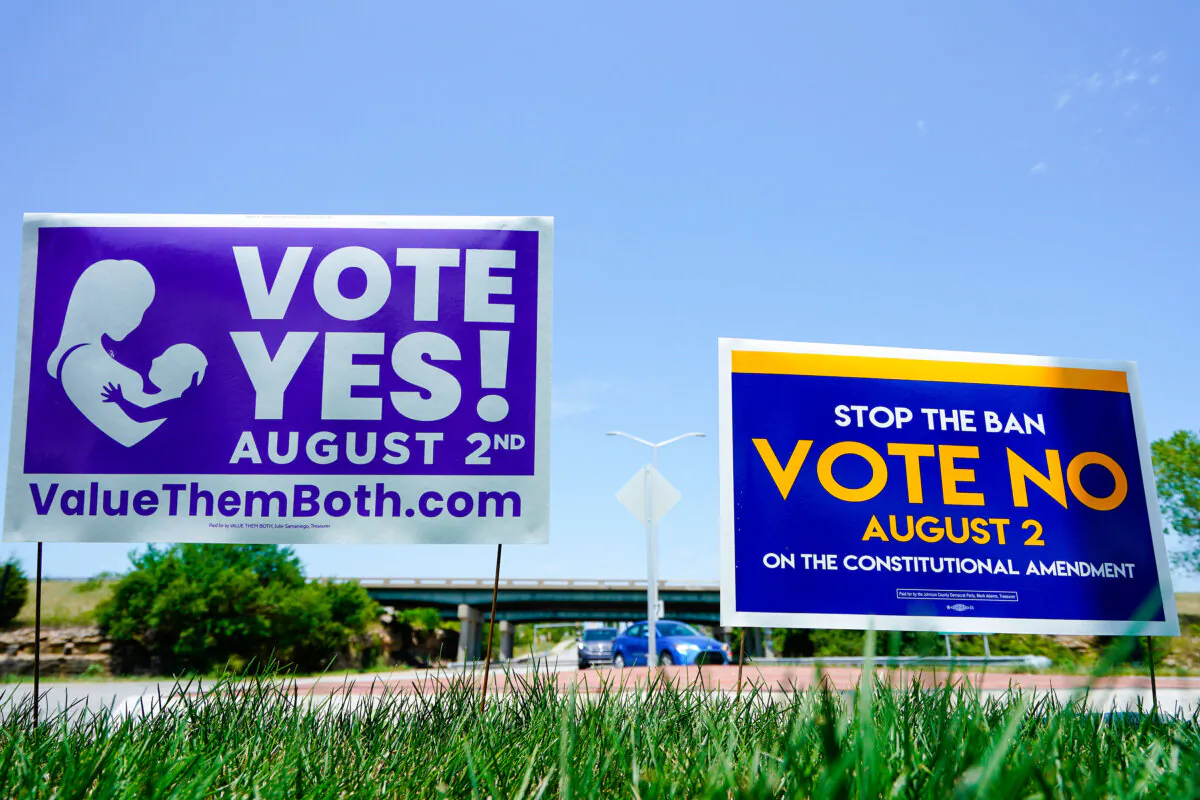 Signs in favor of and against a Kansas constitutional amendment on abortion are displayed outside the Kansas 10 highway in Lenexa, Kan., on Aug. 1, 2022. (Kyle Rivas/Getty Images)