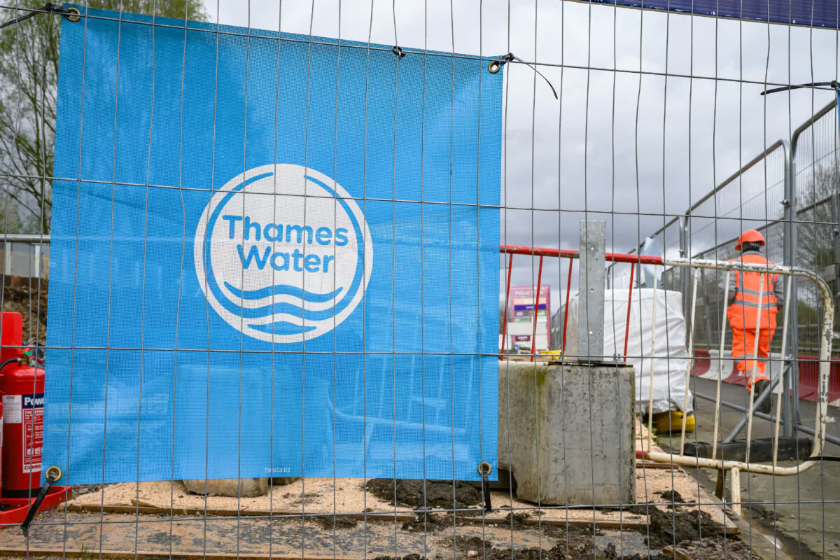 The Thames Water logo is seen on protective fencing around a pipework replacement site in London on April 4, 2024. (Leon Neal/Getty Images)