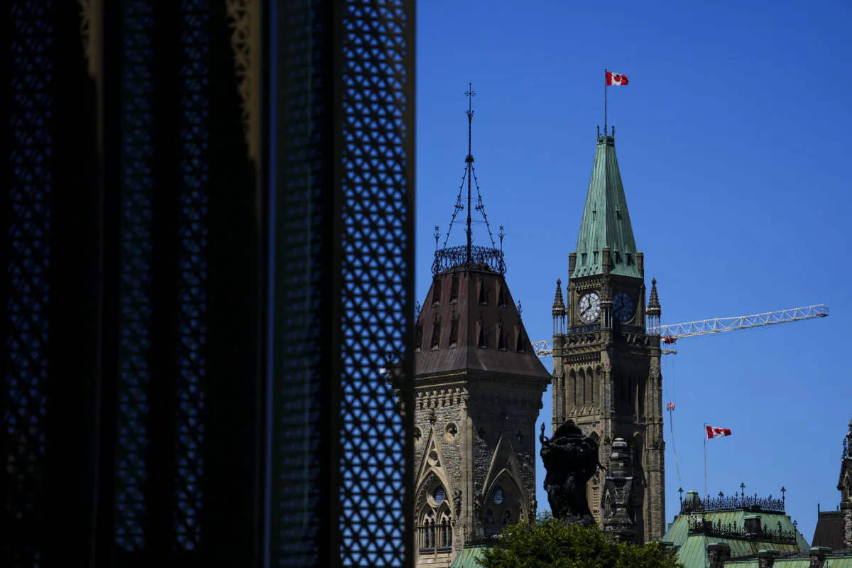 The Canadian flag blows on the Peace Tower on Parliament Hill in Ottawa on June 28, 2024. (The Canadian Press/Sean Kilpatrick)