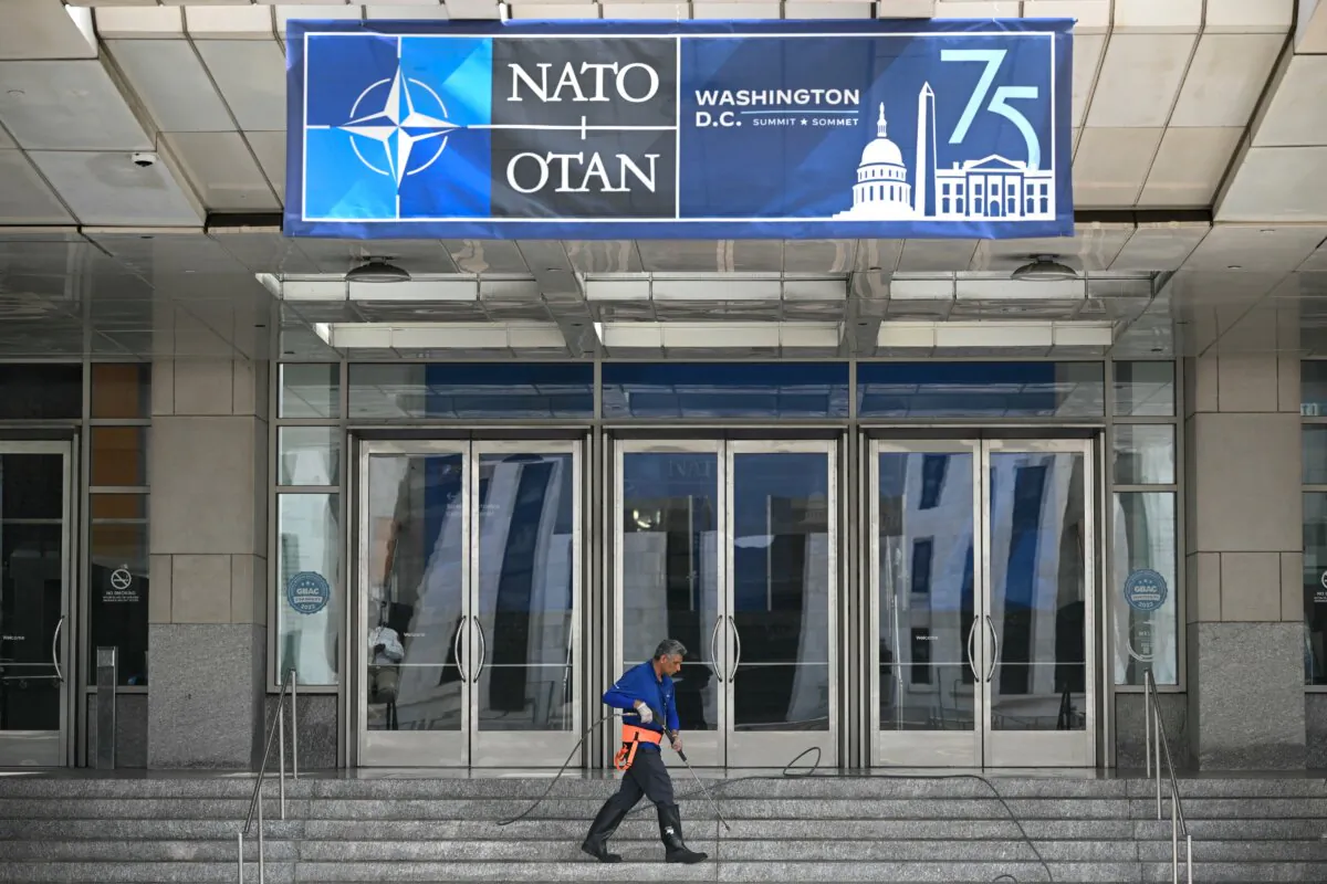 A worker cleans steps outside of the Washington convention center where the NATO summit will be taking place in Washington, DC, from July 9th to the 11th. (Photo by Mandel NGAN / AFP)
