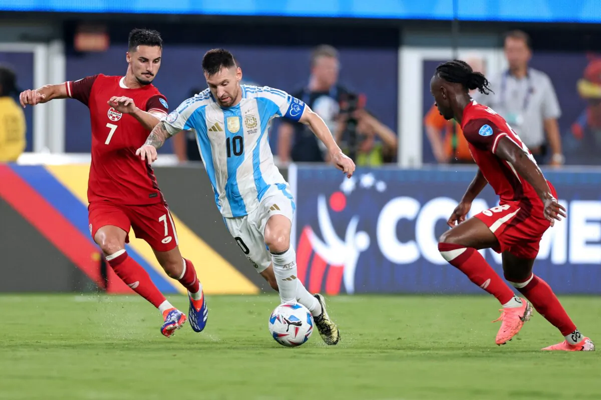 Argentina's forward (10) Lionel Messi fights for the ball with Canada's midfielder (7) Stephen Eustaquio and Canada's midfielder (8) Ismael Kone during the Conmebol 2024 Copa America tournament semi-final football match between Argentina and Canada in East Rutherford, New Jersey on July 9, 2024. (Charly Triballeau/AFP)