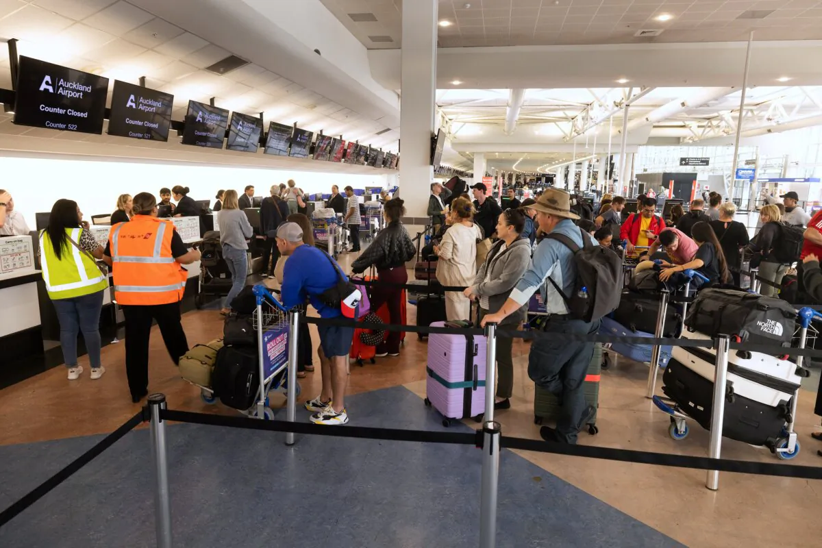 Passengers stand in check-in counters at Auckland International Airport in Auckland, New Zealand, on March 12, 2024. (Brett Phibbs/AFP via Getty Images)