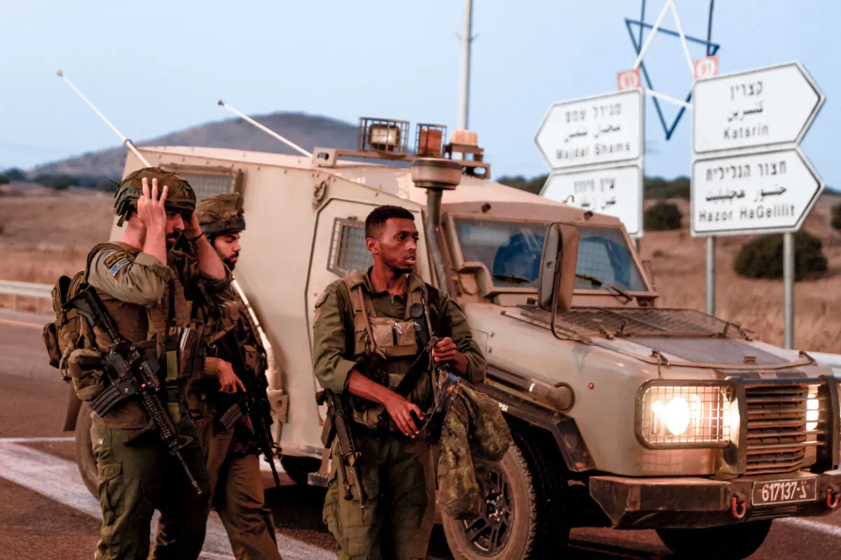 Israeli soldiers secure a road as rockets are launched from southern Lebanon on July 9, 2024. (JALAA MAREY/AFP via Getty Images)