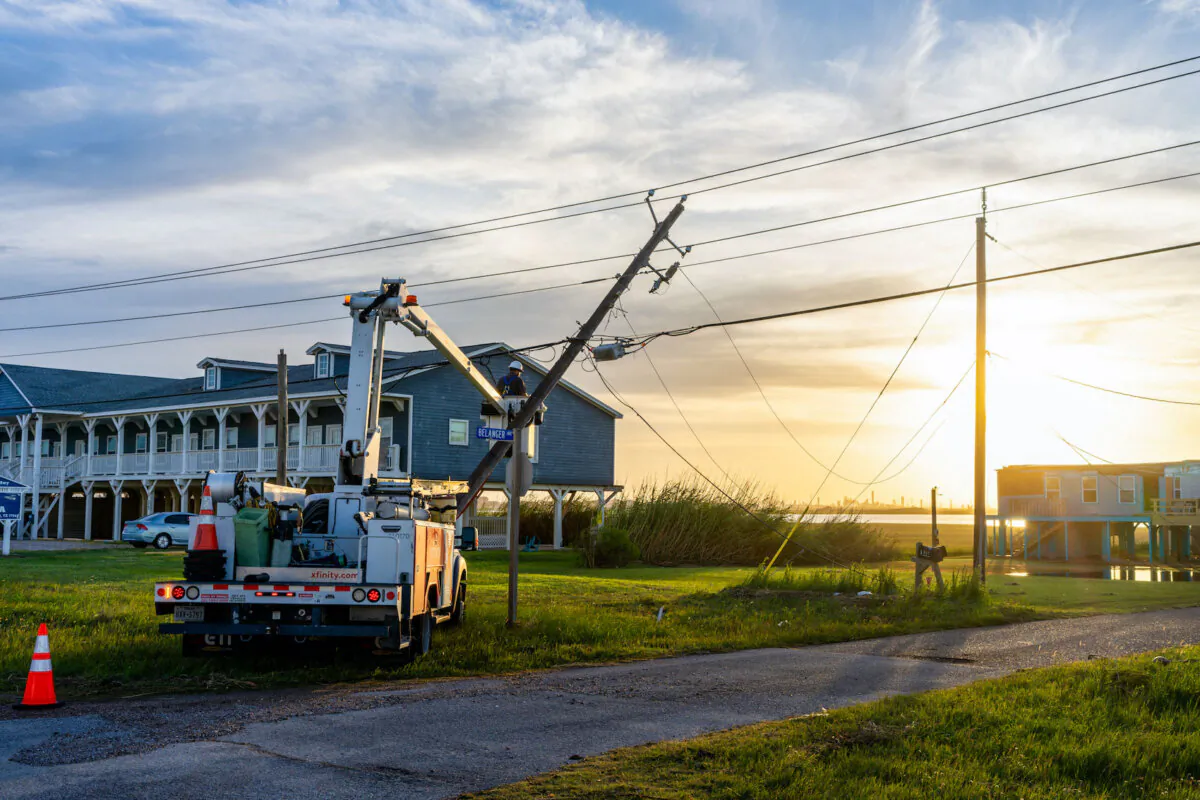 A utility worker restores a damaged powerline after Hurricane Beryl swept through Surfside, Texas, on July 8, 2024. (Brandon Bell/Getty Images)