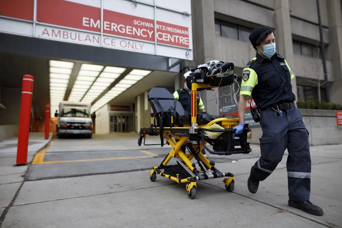 A paramedic wheels a gurney out from the emergency department at Mount Sinai Hospital in Toronto on Jan. 13, 2021. (The Canadian Press/Cole Burston)