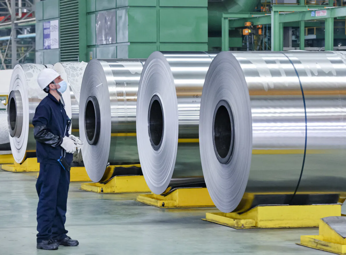 An employee looks on at steel rolls at a factory in Nantong, in China's eastern Jiangsu Province, on March 1, 2022. (STR/AFP via Getty Images)