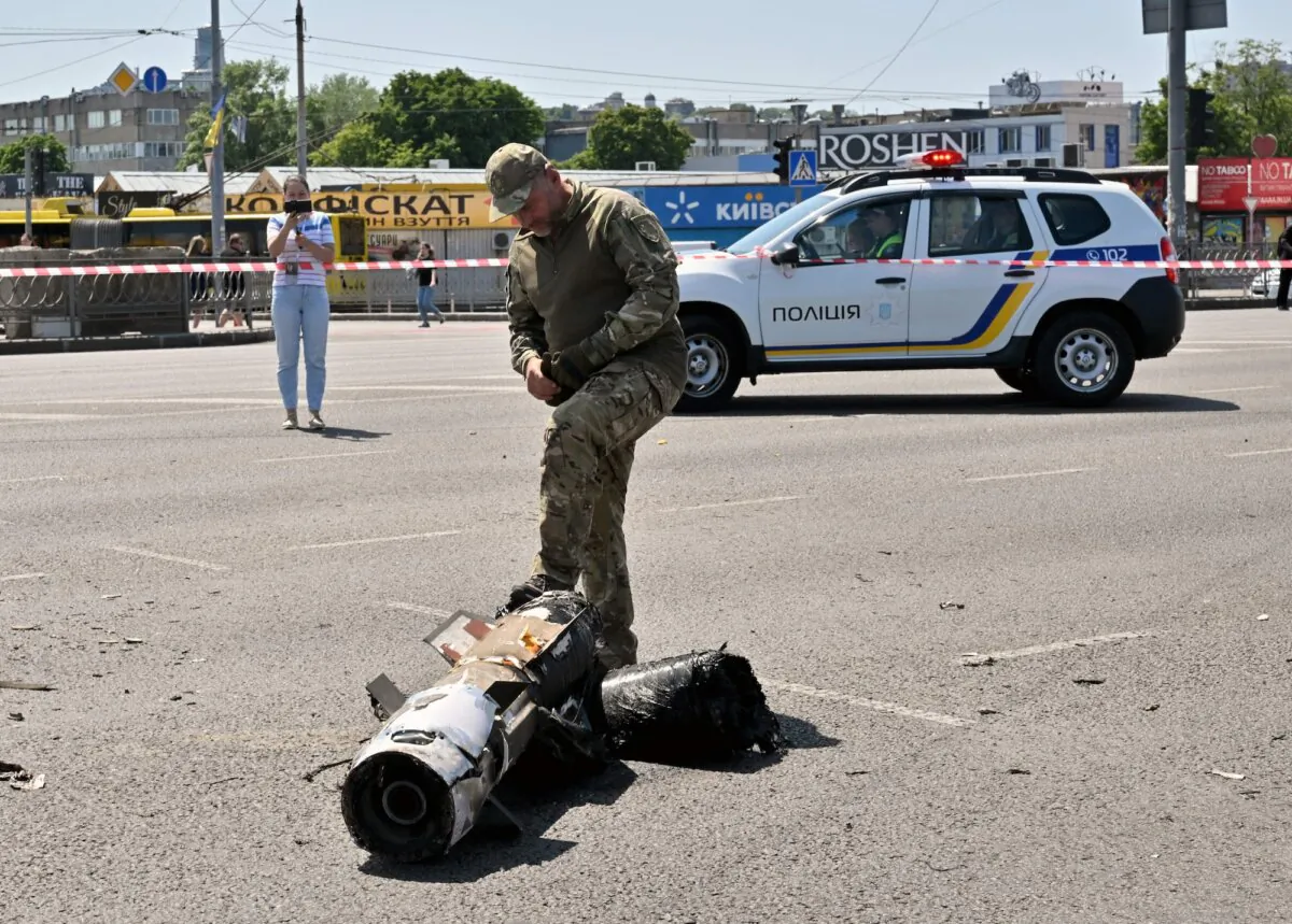 A police expert examines fragments of a Russian missile that targeted the Ukrainian capital, in Kyiv, Ukraine, on May 29, 2023. (Sergei Supinsky/AFP via Getty Images)