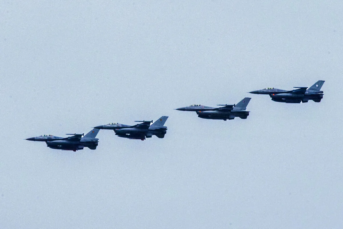 Four Dutch F-16s fly near the Leeuwarden Air Base near Leeuwarden, Netherlands, on Sept. 25, 2014. (Vincent Jannink/AFP/Getty Images)