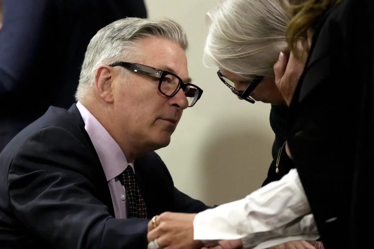 Actor Alec Baldwin speaks with sister Elizabeth Keuchler during a break in his hearing in Santa Fe County District Court in Santa Fe, N.M., on July 10, 2024. (Ross D. Franklin/Pool via AP Photo)