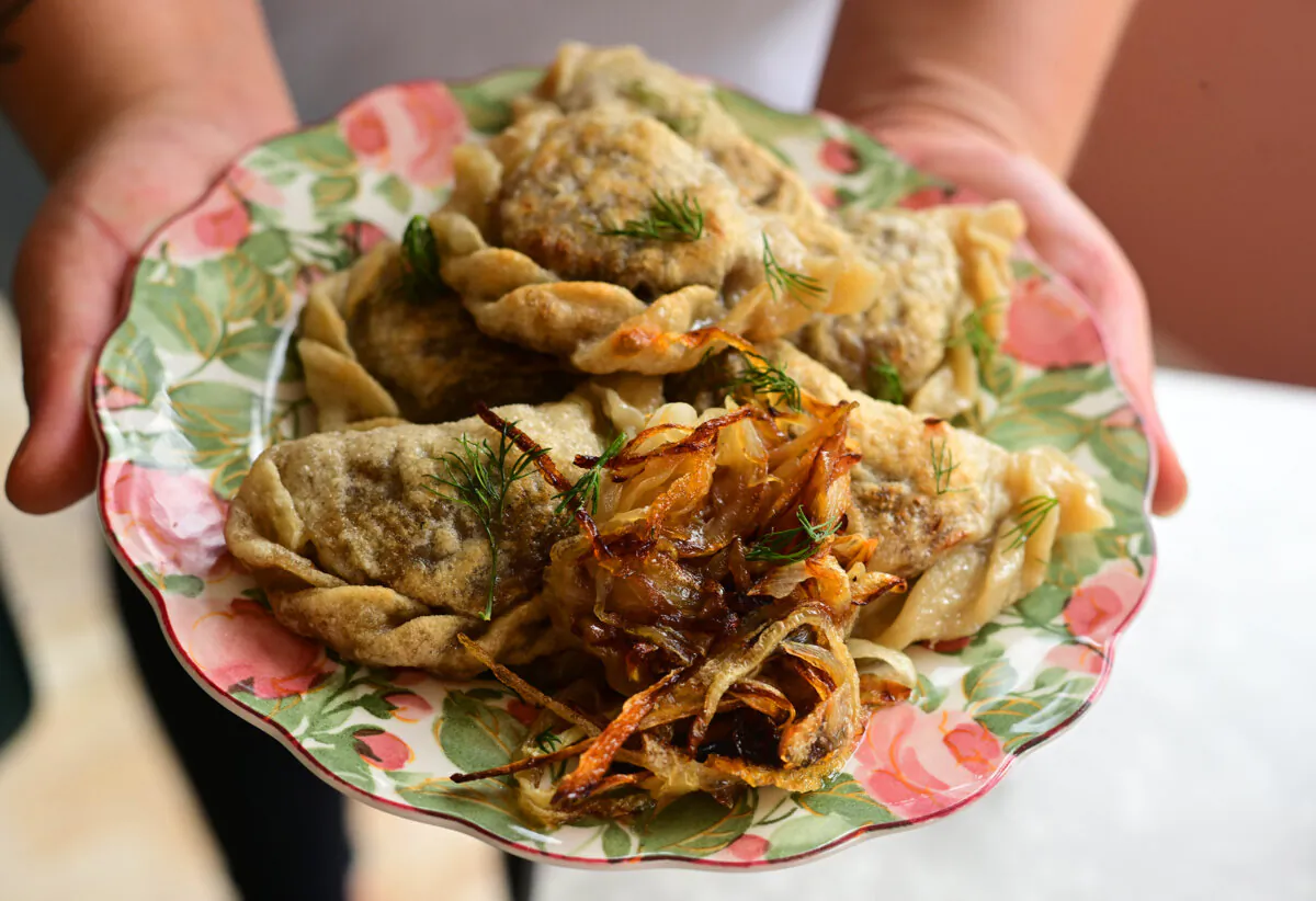 Olive Visco, owner of Polska Laska, holds her signature pierogi in her Sharpsburg restaurant. (Lucy Schaly/Pittsburgh Post-Gazette/TNS)