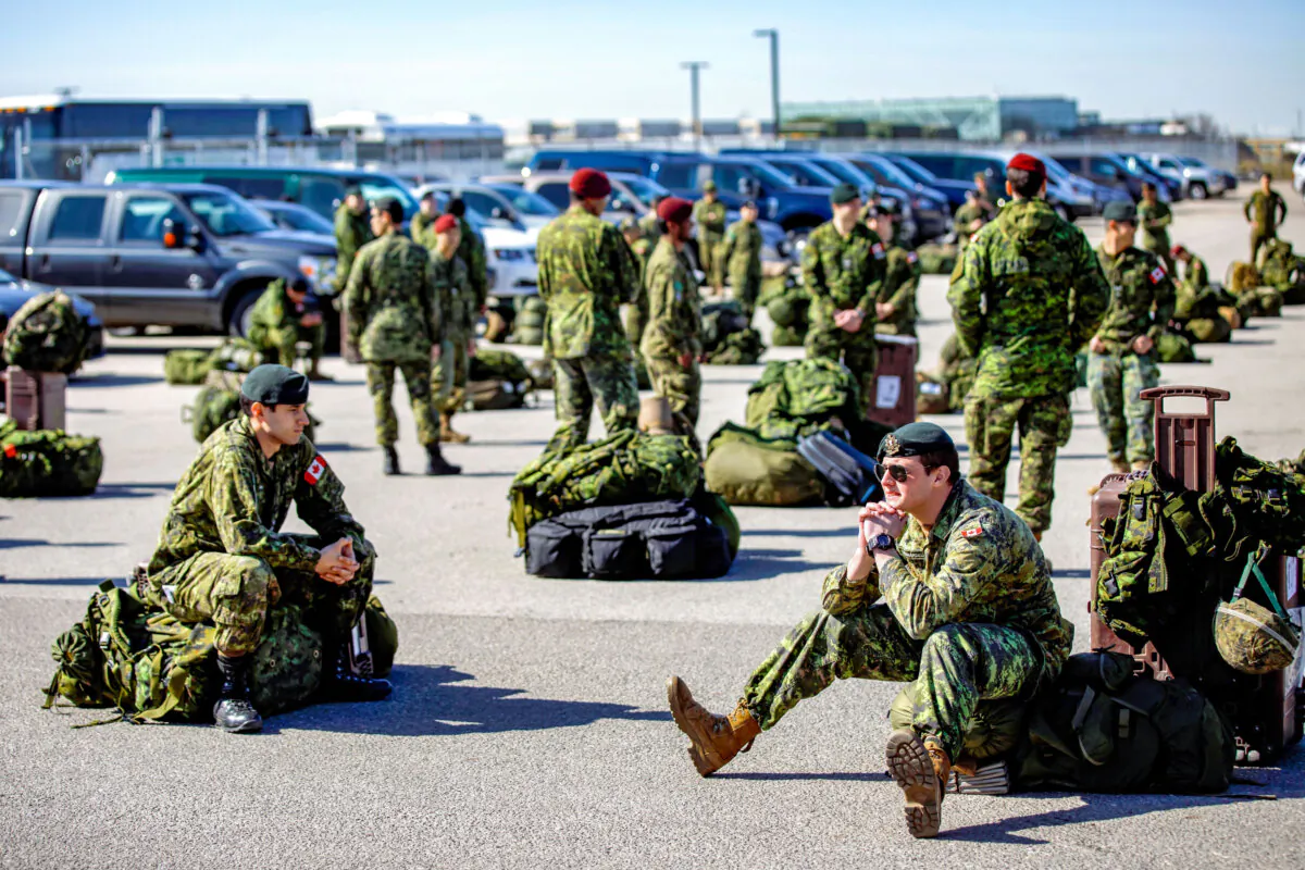 Members of the Canadian Armed Forces wait to convoy to CFB Borden in Toronto on April 6, 2020. (Cole Burston/Getty Images)