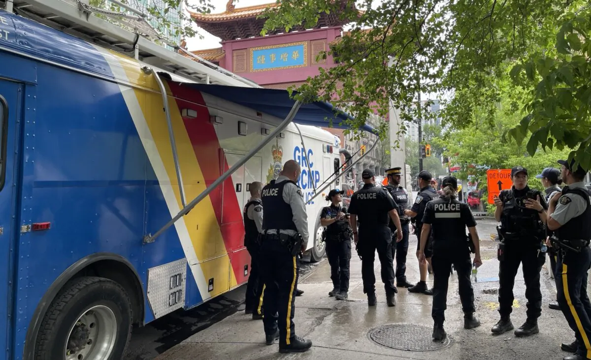 RCMP officers hold an event in Montreal's Chinatown to raise awareness about interference by Beijing, on July 10, 2024. (Noé Chartier/The Epoch Times)