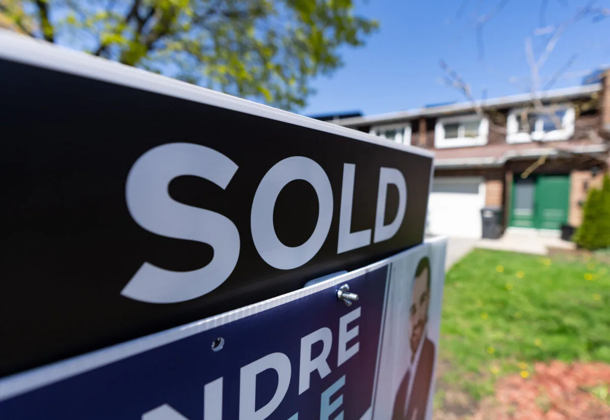 A real estate sign is posted outside a home in Pointe-Claire, a city in Montreal's West Island, on May 7, 2024. (The Canadian Press/Christinne Muschi)
