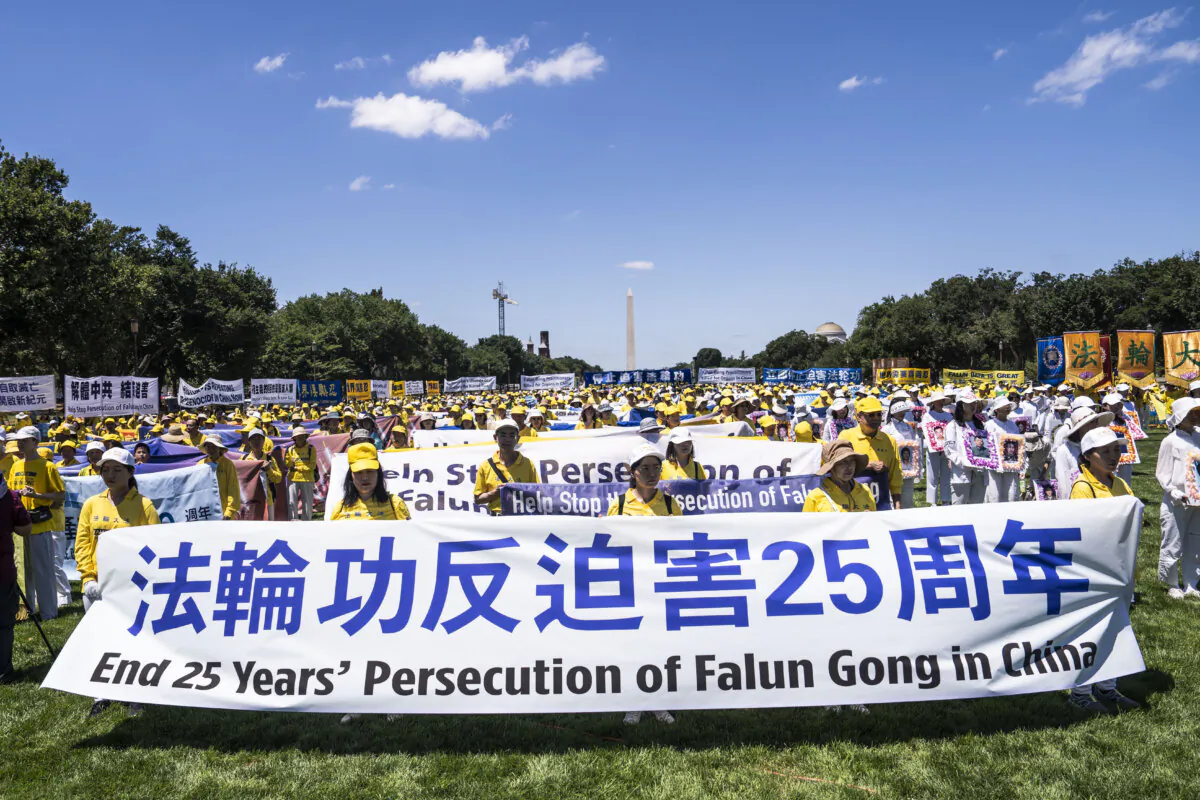Falun Gong practitioners take part in a rally calling for an end to the Chinese Communist Party’s 25 years of ongoing persecution of Falun Gong, at the National Mall in Washington on July 11, 2024. (Madalina Vasiliu/The Epoch Times)