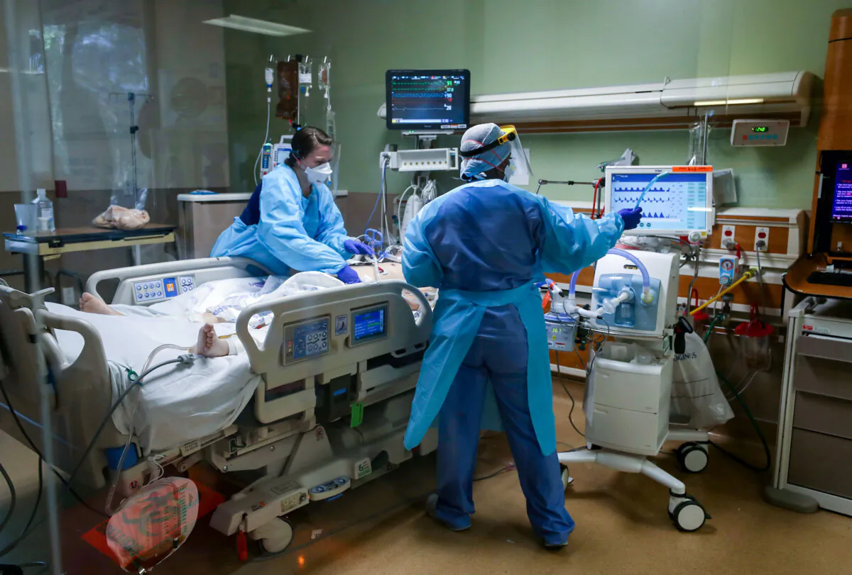 For many patients, medical debt is the beginning of a downward spiral. Above, nurses care for a patient in an intensive care unit. (Justin Sullivan/Getty Images)
