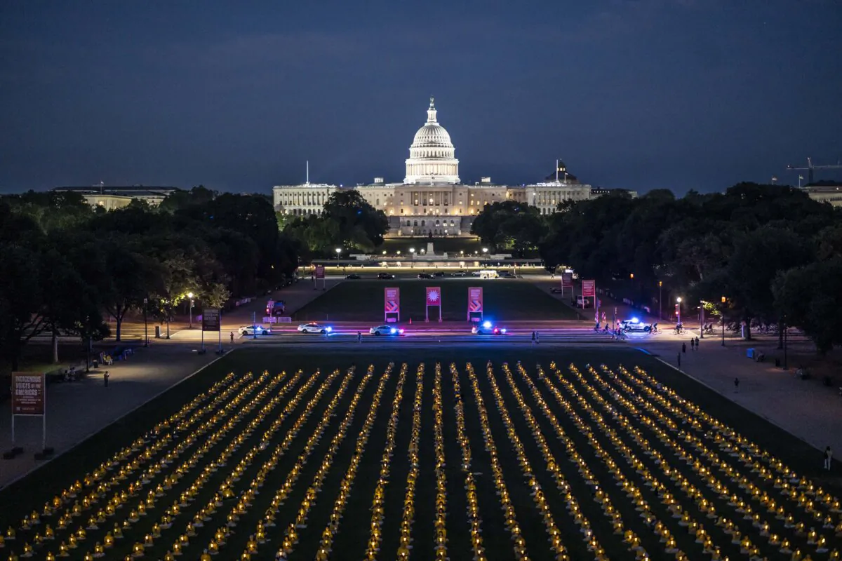 Falun Gong practitioners gather for a candlelight vigil commemorating Falun Gong practitioners’ persecution to death in China by the Chinese Communist Party at the National Mall in Washington on July 11, 2024. (Madalina Vasiliu/The Epoch Times)
