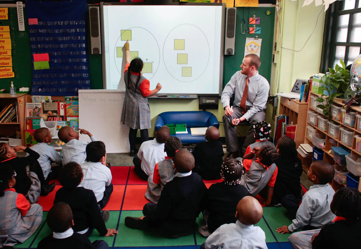 Teacher Shawn Abernathy (R) teaches math concepts using a modern computer projection board at Harlem Success Academy, a free, public elementary charter school in the Harlem neighborhood of New York City on March 30, 2009. Enrollment in schools offering TESOL certification. (Chris Hondros/Getty Images)