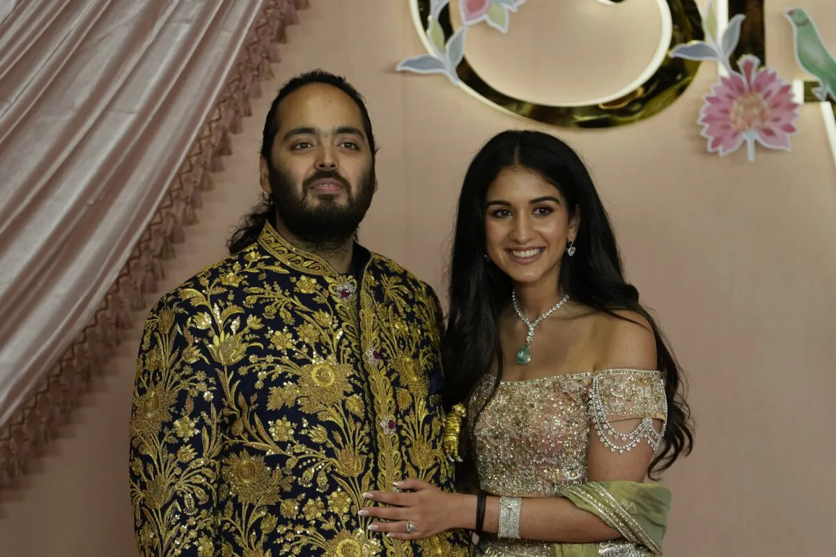 Anant Ambani (L) and Radhika Merchant pose for photographers during their pre-wedding ceremony in Mumbai, India, on July 5, 2024. (Rajanish Kakade/AP Photo)