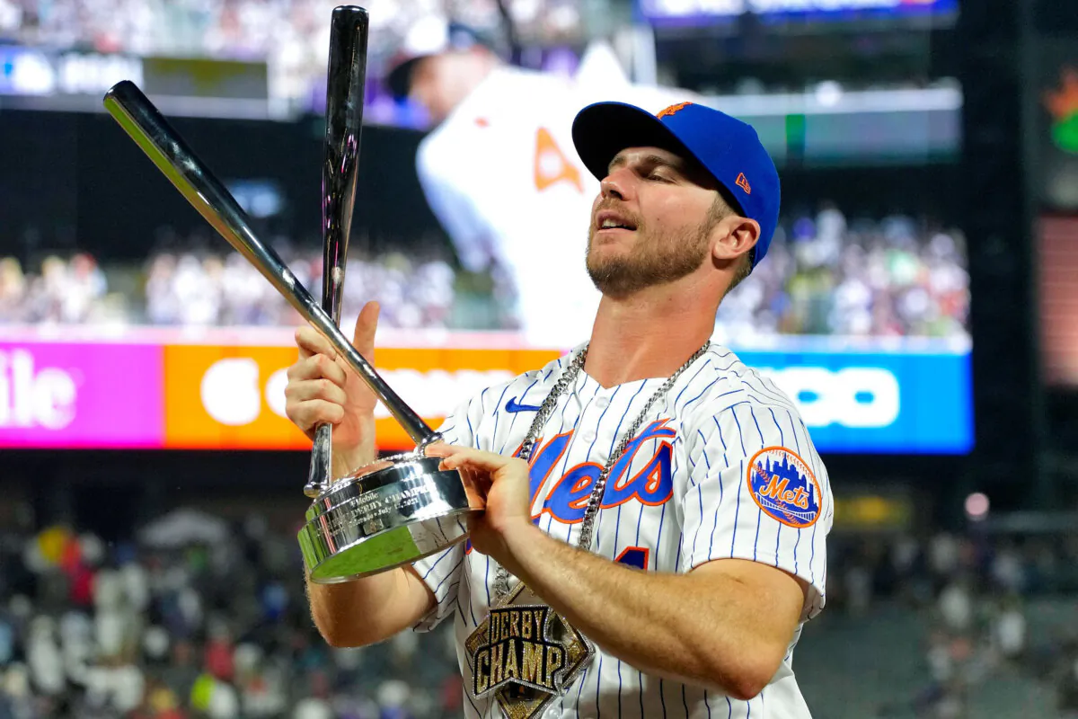 National League's Pete Alonso, of the New York Mets, holds the champions trophy after winning the MLB All Star baseball Home Run Derby in Denver on July 12, 2021. (David Zalubowski/AP Photo)