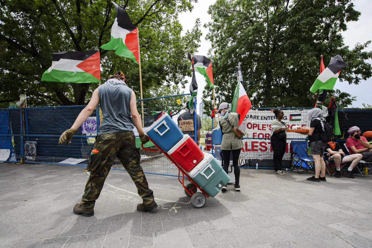 Protesters remove a pro-Palestinian encampment that had been set up on the University of Toronto campus, on July 3, 2024. (The Canadian Press/Christopher Katsarov)