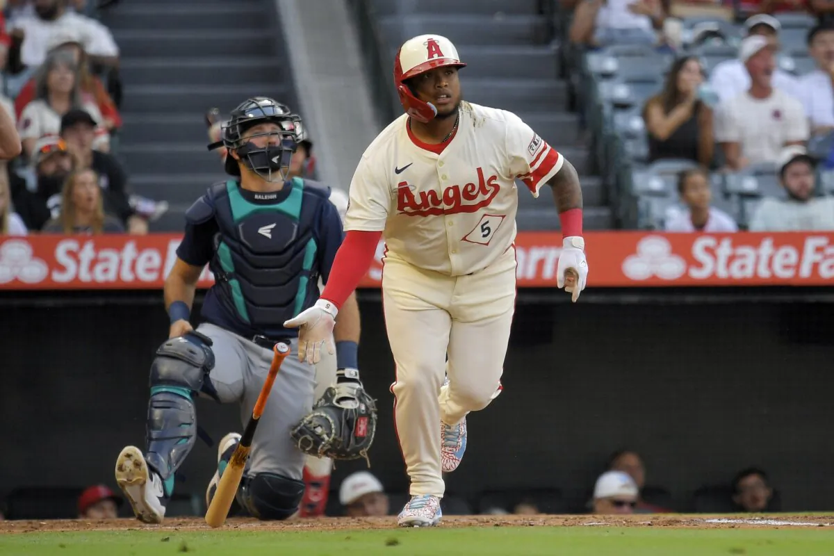 Los Angeles Angels' Willie Calhoun (R) heads to first for a two-run home run as Seattle Mariners catcher Cal Raleigh watches during the first inning of a baseball game in Anaheim, Calif. , on July 12, 2024. (Mark J. Terrill/AP Photo)