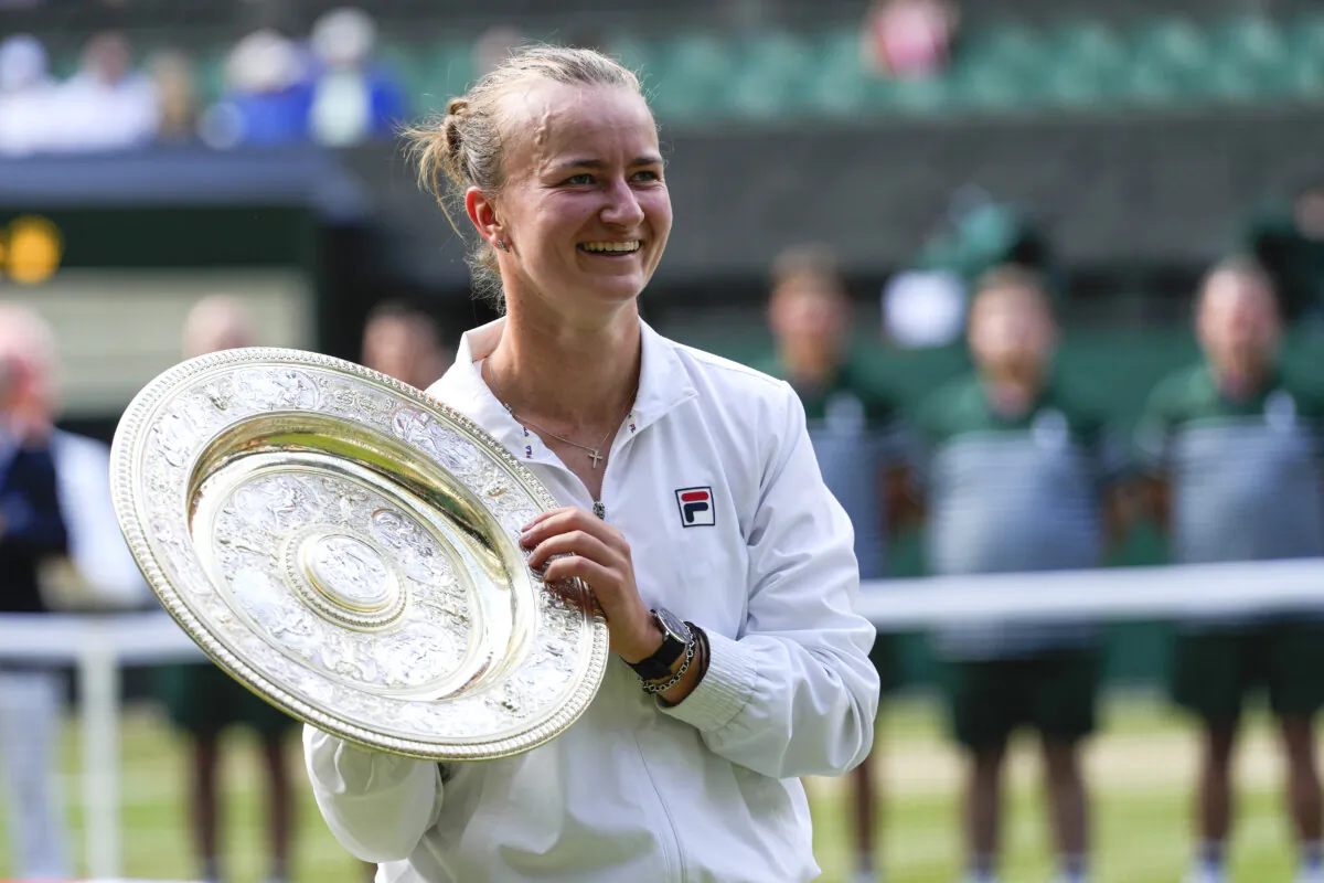 Barbora Krejcikova of the Czech Republic holds her trophy after defeating Jasmine Paolini of Italy in the women's singles final at the Wimbledon tennis championships in London on July 13, 2024. (Kirsty Wigglesworth/AP Photo)