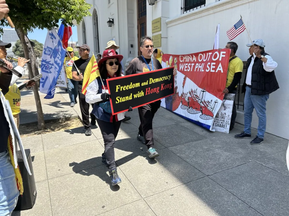 Dozens of Asian Americans rally and march in front of the Chinese Consulate calling on the Chinese regime to stop its expansion and aggression in the South China Sea, in San Francisco on July 12, 2024. (Nathan Su/The Epoch Times)