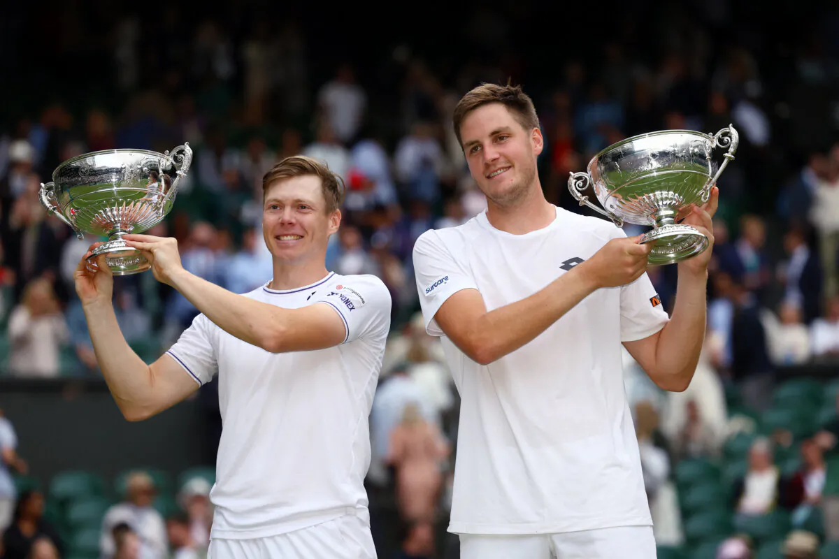 Britain's Henry Patten and Finland's Harri Heliovaara celebrate with their trophies after winning the men's doubles final against Australia's Max Purcell and Australia's Jordan Thompson at the Wimbledon tennis championships in London on July 13, 2024. (Paul Childs/Reuters)