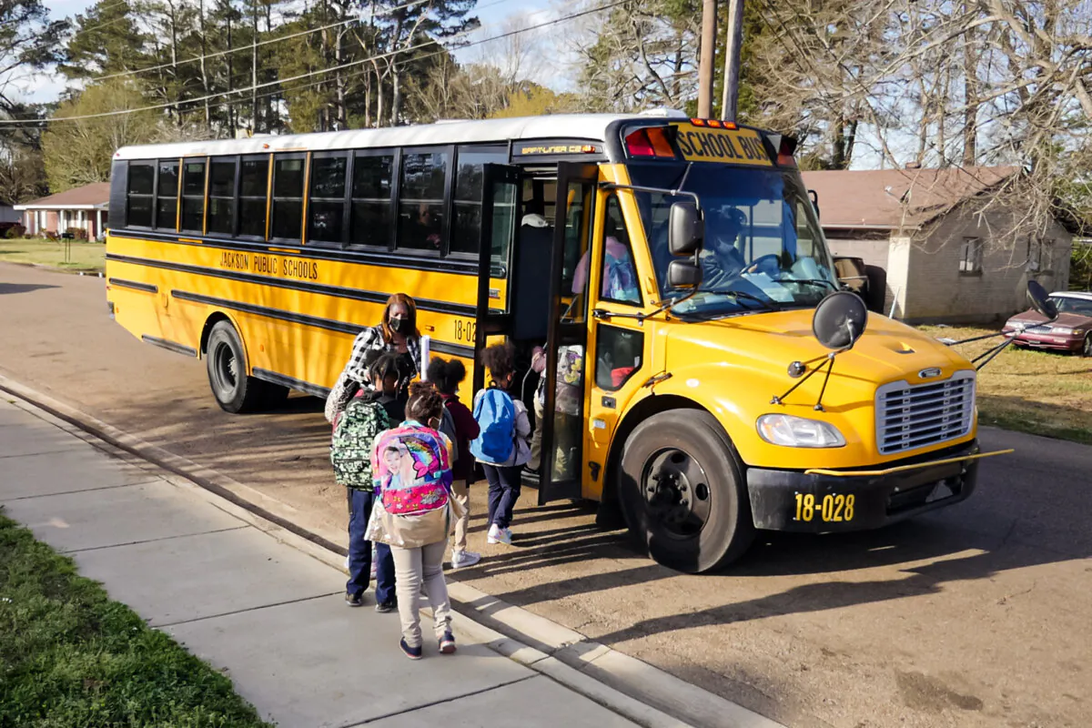 Children board a school bus in Jackson, Miss., on March 24, 2022. (Francois Picard/AFP via Getty Images)
