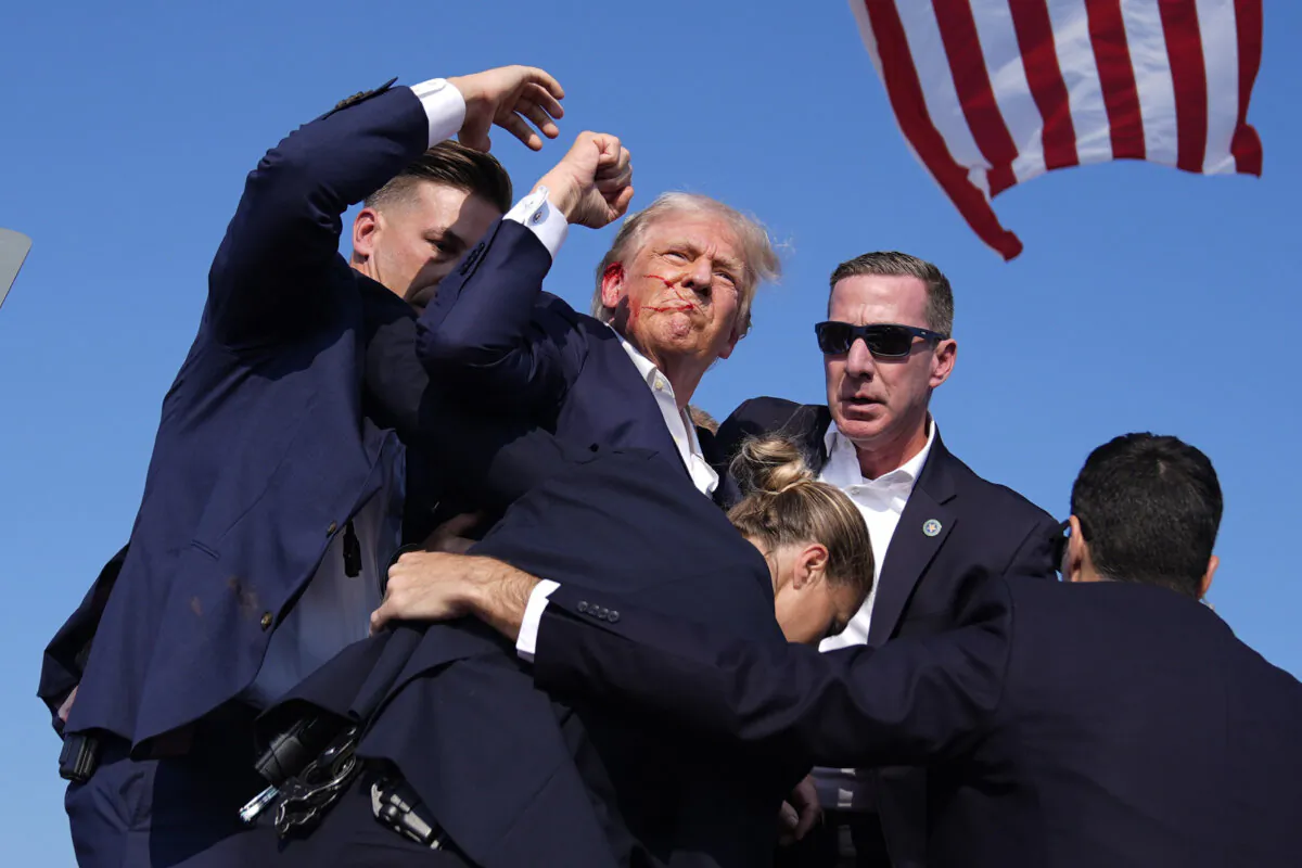 Republican presidential candidate former President Donald Trump is surround by U.S. Secret Service agents at a campaign rally in Butler, Pa., on July 13, 2024. (Evan Vucci/AP Photo)