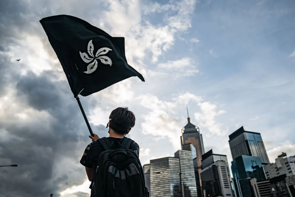 A man waves a black Hong Kong flag on a street outside the Legislative Council Complex in Hong Kong on July 1, 2019. (Anthony Kwan/Getty Images)