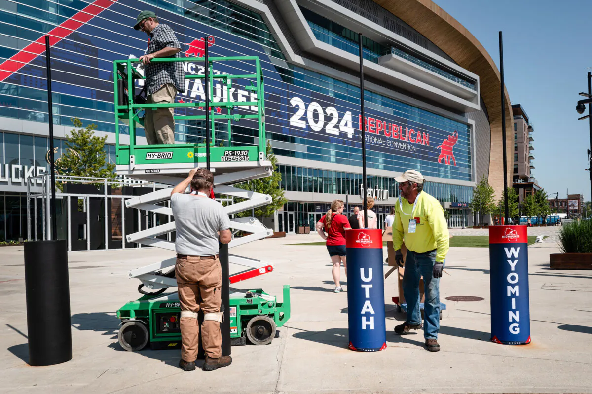 Workers install decorations outside the Fiserv Forum in preparation for the Republican National Convention (RNC) in Milwaukee on July 12, 2024. The RNC will be held from July 15–18. (Scott Olson/Getty Images)
