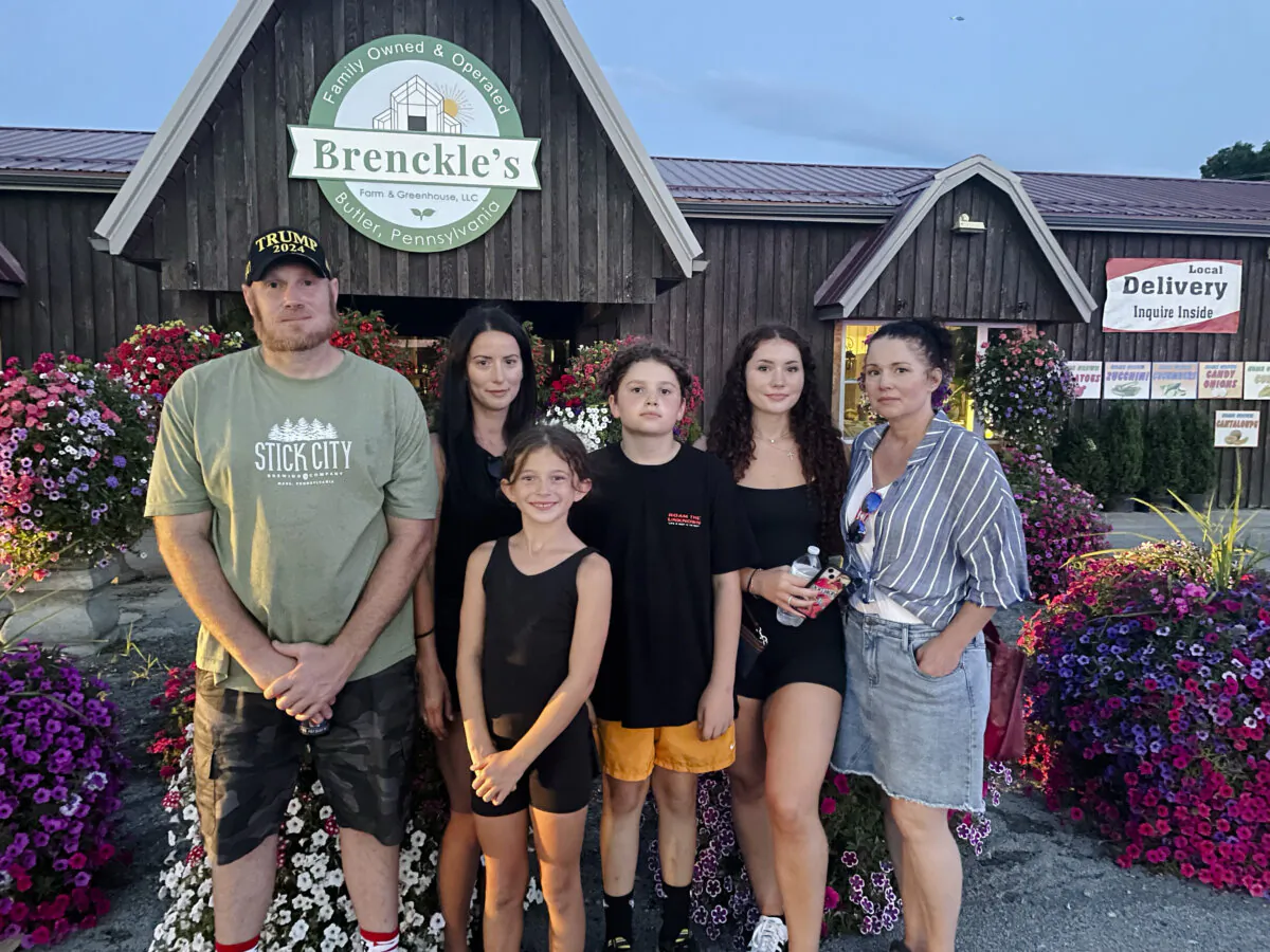 Greg Smith (far L) and his wife Stephanie Costlow (2nd from L) stand in front of their business in Butler, Pennsylvania, on July 13, 2024. (Rachel Wang/The Epoch Times)