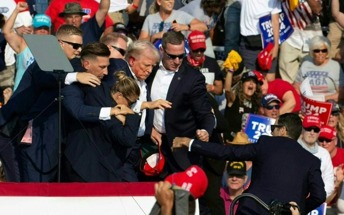 Secret Service agents surround former President Donald Trump as he is taken off the stage after being shot at a campaign event at Butler Farm Show Inc. in Butler, Pa., on July 13, 2024. (Rebecca Droke/AFP via Getty Images)