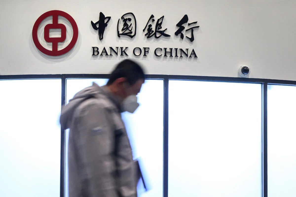 A man walks past a booth of the Bank of China at the Main Press Centre of the 2022 Winter Olympics in Beijing on Jan. 28, 2022. (Fabrice Coffrini/AFP via Getty Images)