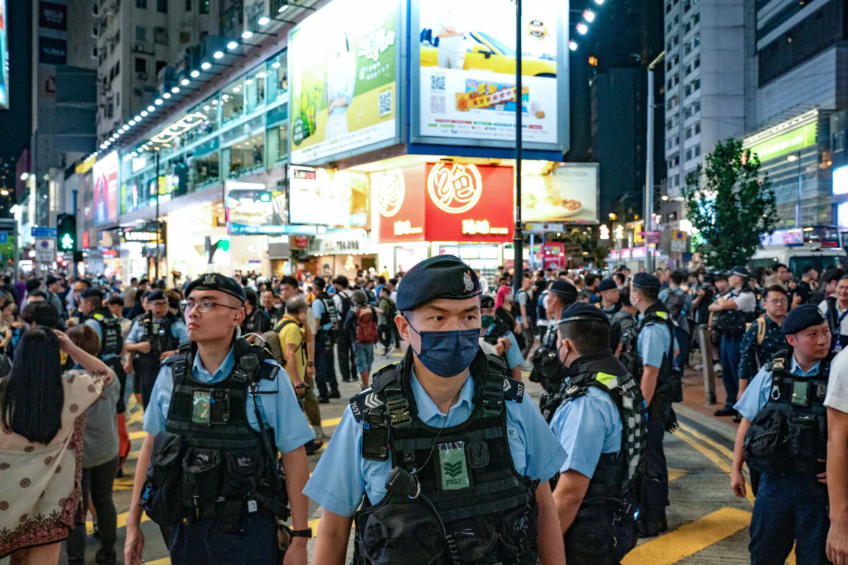 Police officers patrol Hong Kong's Causeway Bay district near Victoria Park where people traditionally gathered annually to mourn the victims of China's Tiananmen Square crackdown in 1989 on June 4, 2024. Since the new national security law has gone into effect, the event no longer takes place. (Anthony Kwan/Getty Images)
