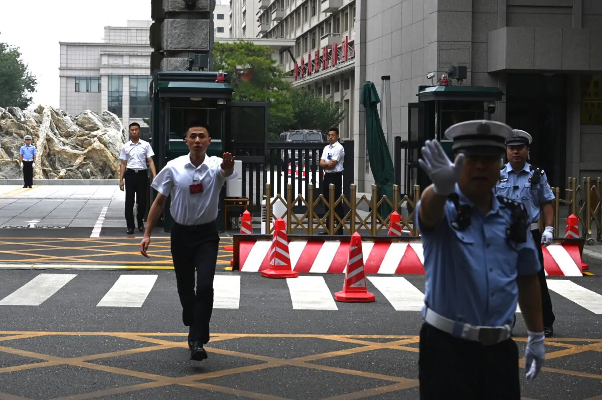 Security guards stand outside the Jingxi Hotel, where Chinese officials were conducting the Third Plenum, a key economic meeting, in Beijing on July 15, 2024. (Greg Baker/AFP via Getty Images)