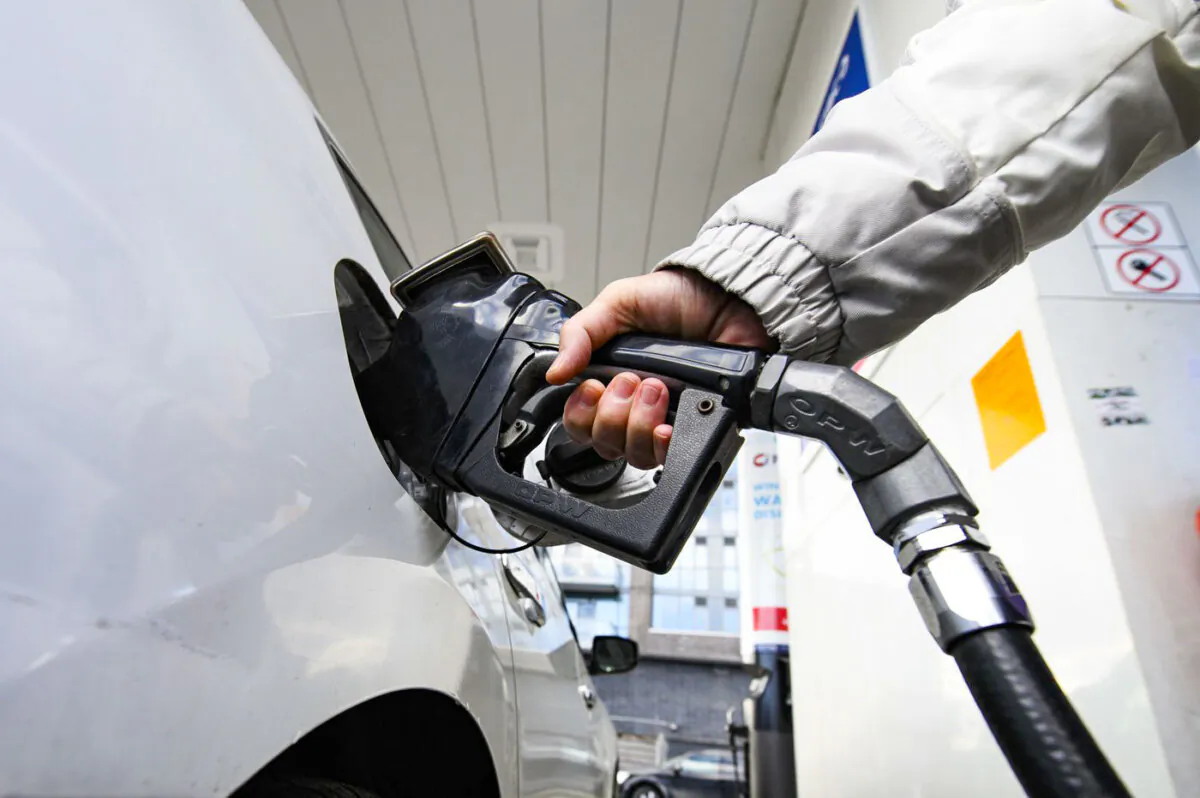 A woman gasses up at a gas station in Mississauga, Ont., on Feb. 13, 2024. (The Canadian Press/Christopher Katsarov)